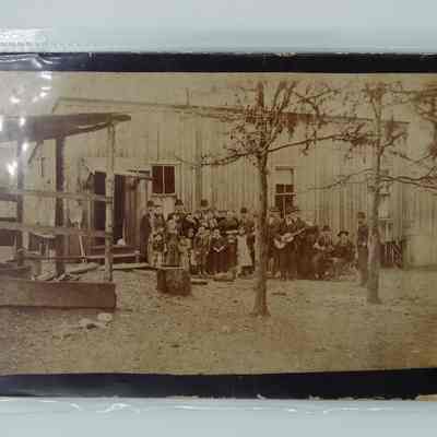 Group of people in front of wood building