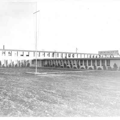 Side view of the Navy Base school with empty pole and a large sign for Clover Park School District 400 on top