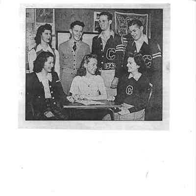 Several young adults some in Clover Park letter jackets or sweaters