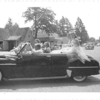 Princesses Gail Baker & Rita Gardner, as well as flower girl Alice Anderson, in convertible, followed by girl scouts