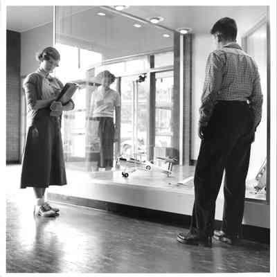 Hudtloff Junior High School students looking at model plane in case 1953