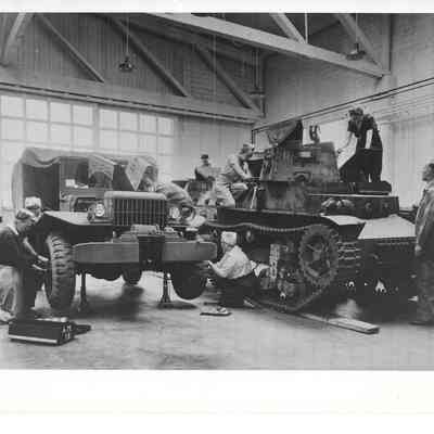 Women working on tank and car