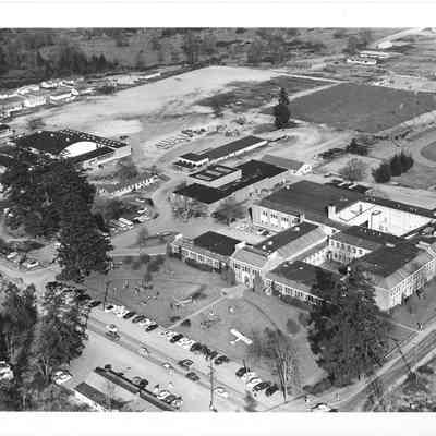 Distant aerial shot of the front of Clover Park High School with several planes parked on front lawn