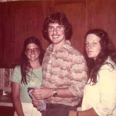 Photograph of Paul Coombes and two unidentified women, 1977