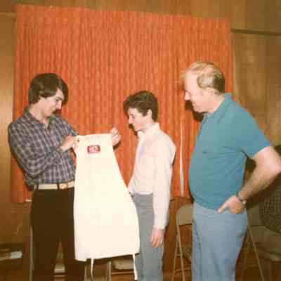 Photograph of Thierry Huguet and two unknown people at AFS Spaghetti Dinner, Mar 1983