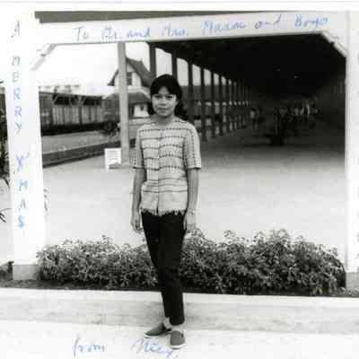 Photograph of Nic with Christmas message to Mason family, 1965