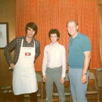 Photograph of Thierry Huguet and two unknown people at AFS Spaghetti Dinner, Mar 1983