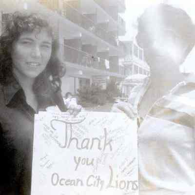 Photograph of Azy Durrer and unidentified person holding ‘Thank you Ocean City Lions’ sign