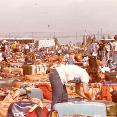 Photograph of suitcases and unidentified people