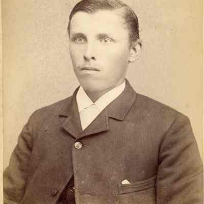 Photo portrait of a young white man in a suit with a mole above his mouth on the right. Photographed by Boyd (successor to Judkins) located on the corner of Second & Columbia Streets in Seattle WA.: 2024.III.I.3.b.004