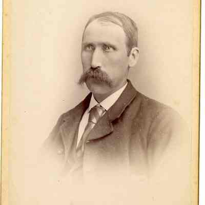 Photo Portrait of an older white gentleman in a suit and sporting a bushy moustache. Photographed by Booen & Ewing in LaConner, WA.: 2024.III.I.3.b.006
