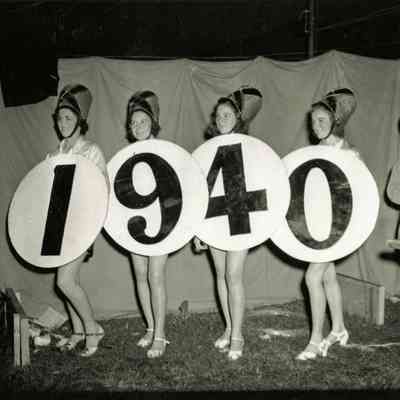 Women Wearing 1940 Sign