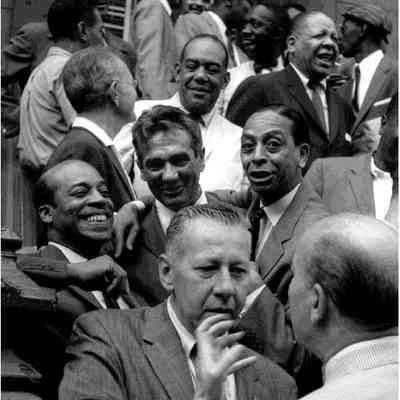 The Drummers (First row) George Wettling and Bud Freeman; (Second row) Jo Jones, Gene Krupa, and Sonny Greer; (Third row) Miff Mole, Zutty Singleton, Red Allen, and Taft Jordan; (Top row) Dickie Wells, Buck Clayton, Benny Golson, Art Farmer, Hilton Jefferson, and Art Blakey, Esquire magazine shoot, Harlem, N.Y.C., c. 1959