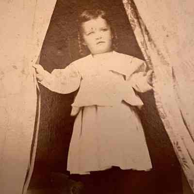 Child peeking through a curtain