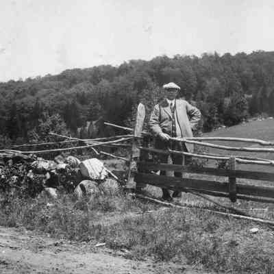 Man next to pasture fence 6-0355