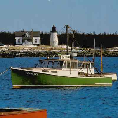 Prospect Harbor Lighthouse and Keeper's Cottage with green lobster boat.