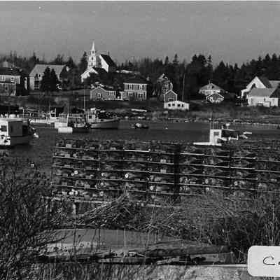 Lobster traps stacked on a wharf in Corea, Maine.