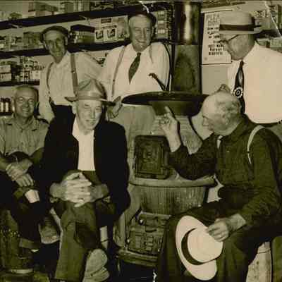 Men gathered around the stove in Byron Moore's store in Prospect Harbor, Maine