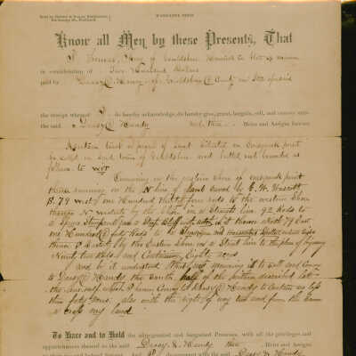 Deed for property transfer from Thomas Arey to Daniel Deasy and Joseph Handy in 1882