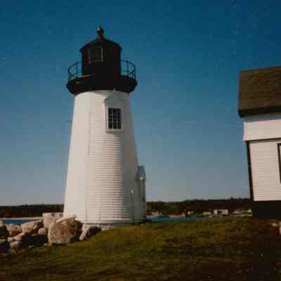 Prospect Harbor Lighthouse on rocky shore.