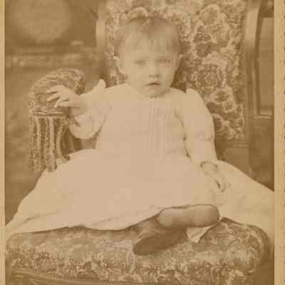 Little girl in a chair.
