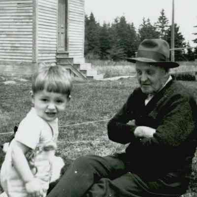 Young John Workman and his great-grandfather, Ira Nash Workman, playing outside of the Prospect Harbor Lighthouse.