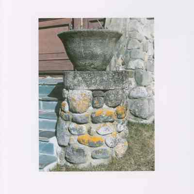 Soderholtz flower pot on stairs of West Gouldsboro Village Library (wide view).