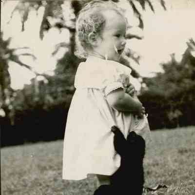 Little girl playing with a bear cub.