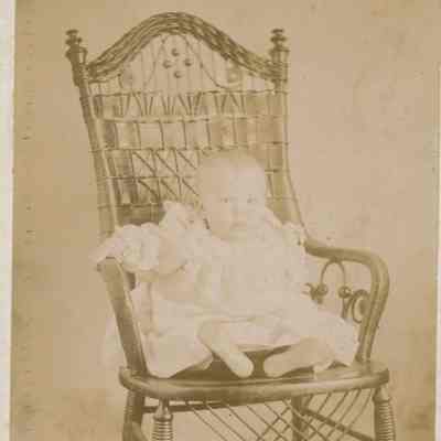 Beulah Bunker in a wicker chair.