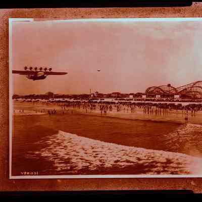 Plane Flying Along Shore
