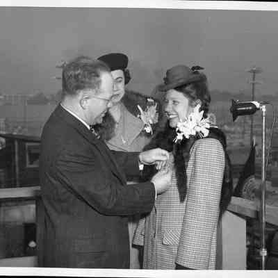 James C. Merrill pinning the Victory emblem pin on Ann Sereven Gillette for the S.S. James Screven Hull #21, November 23, 1943