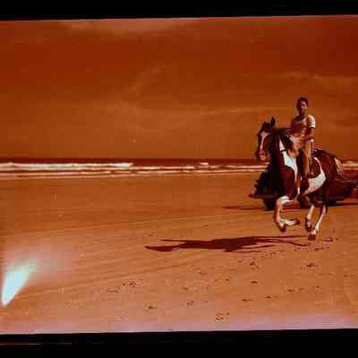 Young Man on Horseback on Beach