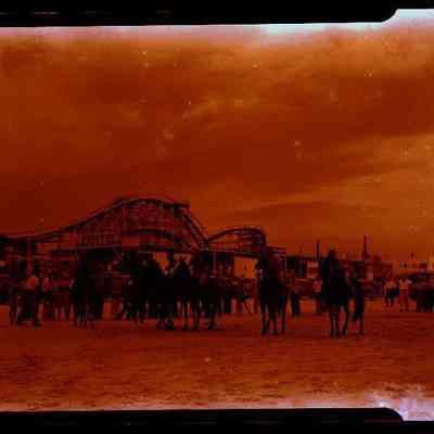 Group on Horseback wtih Roller Coaster