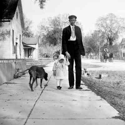 Leah Mary Cox photograph of a man walking a young girl with a dog