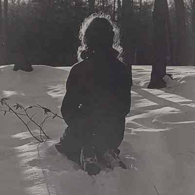 Girl scout kneeling in snow