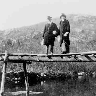 Two people on a wooden bridge