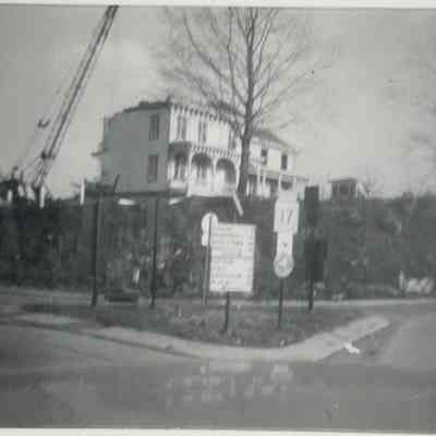 Francis D. Hopper Homestead being torn down in 1952. An old wellhouse can be seen in the photo. The fence post on the left side of the home is the original height of Old Valley Road.