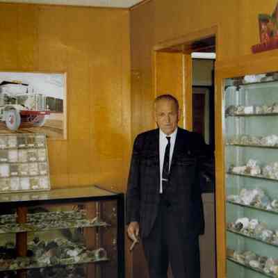 Dave McKee with rock collection in entrance to office
