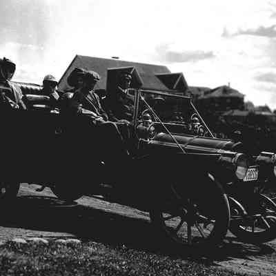 Snow family in an antique car