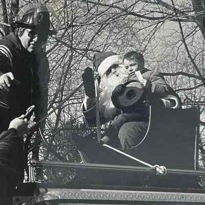 Mahwah firemen bring Santa Claus outside to Mahwah homes, so young children can come out to talk with him in his sled. (1982)
