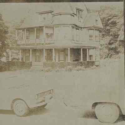 The Kemp House, with two cars in front of it