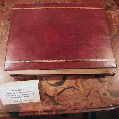 Black & white photographs glued to gray index stock pages, bound in a faux leather album: Red textured, padded cover with gold highlight detail - all photos by Michael Thurston
