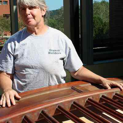 Jody Paine of Graves Builders examines a section of the library balustrade: All photos by Michael Thurston