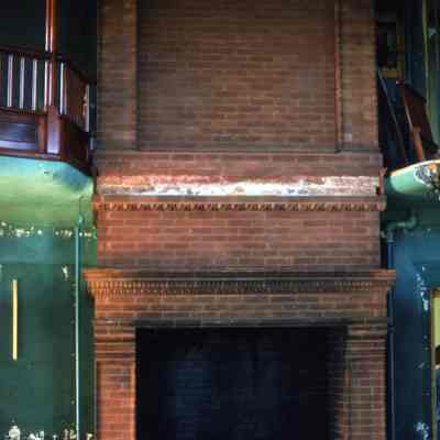T.N. Vail Library in the north tower (LSC college bookstore 1960s-70s) fireplace during the destruction of Vail, 1974: Note that the library balustrade from the mezzanine level has not yet been rescued. See entry 2024.780.1.