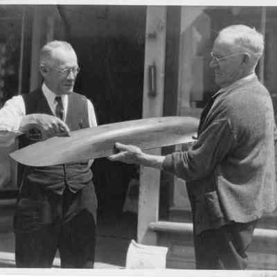 2 men with half-hull model