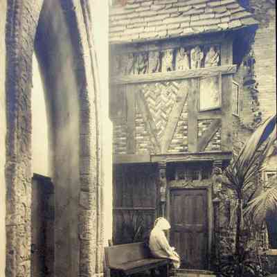 1930s Hammond as a Monk on courtyard bench