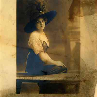 lady with hat sitting on bench