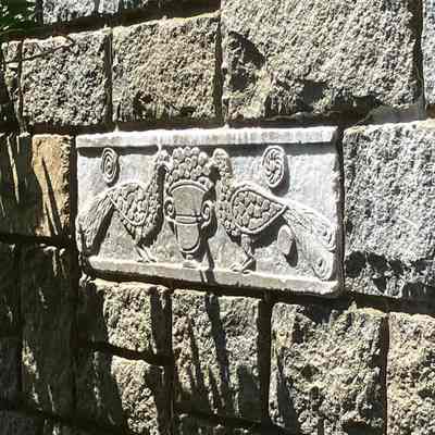 Peacock Plaque (on building along lookout stairs)