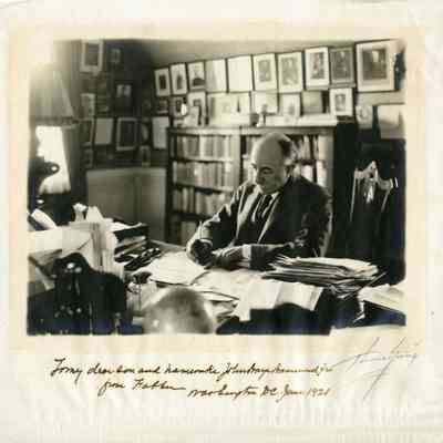 JHHSr at desk writing w inscription, 1921