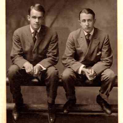 Unknown man and Harris Hammond sitting on a fence